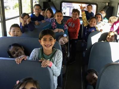 Students ride the bus to White Hall Farms